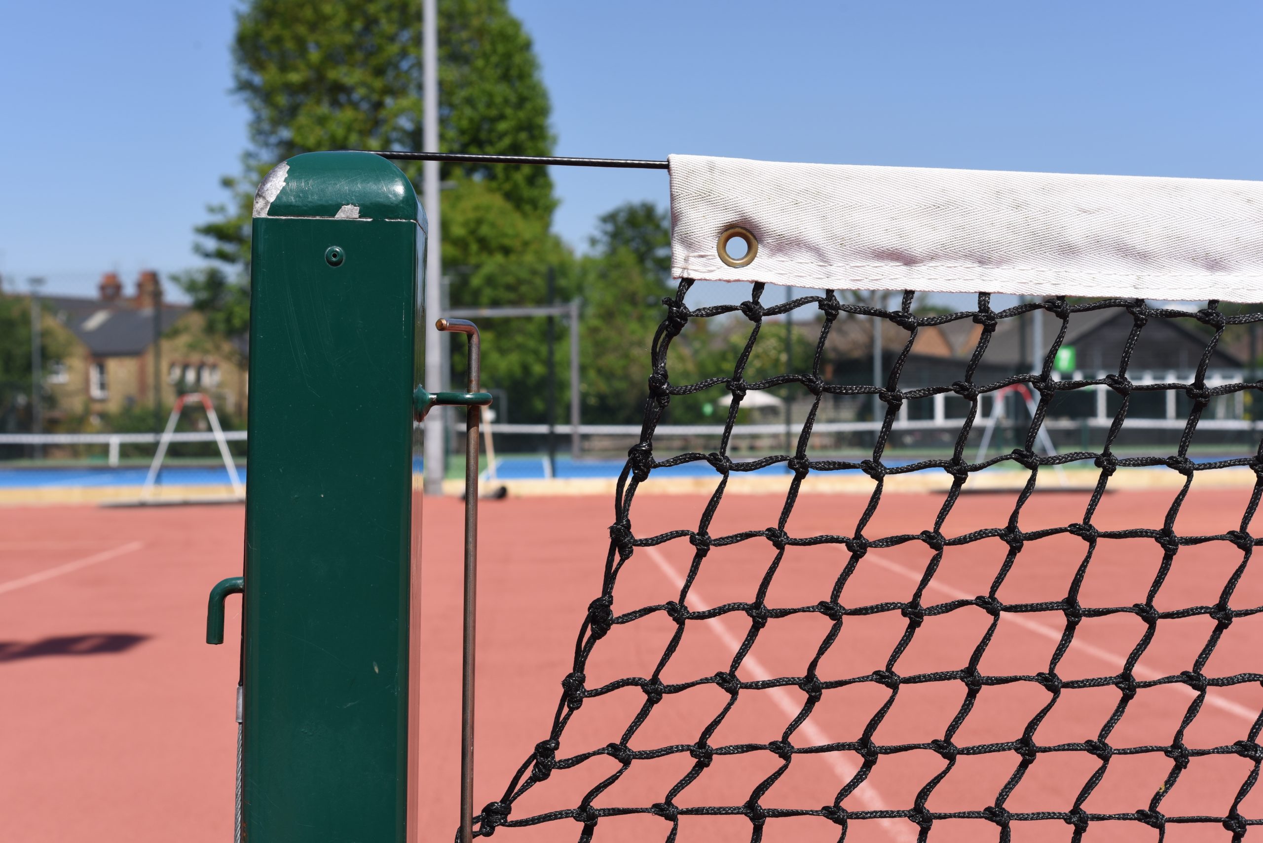 tennis net post on a tennis court close up photo